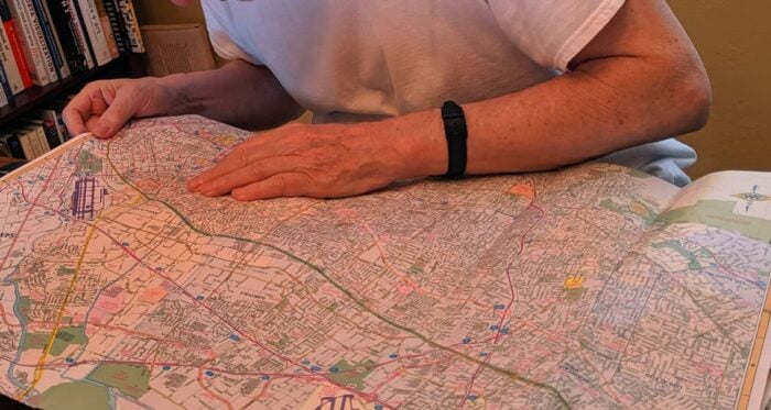 Man reading a street map at a table.