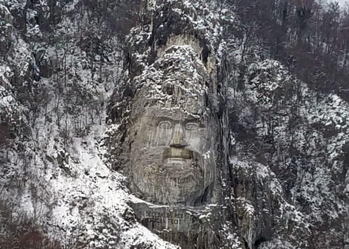 Rock carving, on the Romanian side of the Danube River, depicting the Dacian King Decebalus (r. A.D. 87-106), who fought the Romans in the early 2nd century but was ultimately defeated. He is considered a Romanian national hero. The carving, made between 1994 and 2004, is 42.9 m (141 ft) tall and 31.6 m (104 ft) wide and is the tallest rock relief in Europe. Photo: CIA, public domain.