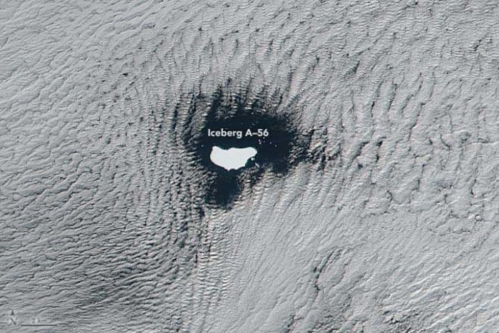 A satellite captured an image of low stratus clouds framing iceberg A-56 as it drifted in the South Atlantic Ocean on June 1, 2016. NASA image by Jeff Schmaltz, LANCE/EOSDIS Rapid Response. Caption by Kathryn Hansen