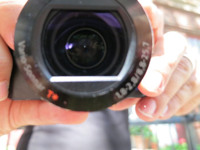 A person holding a camera up to the screen.