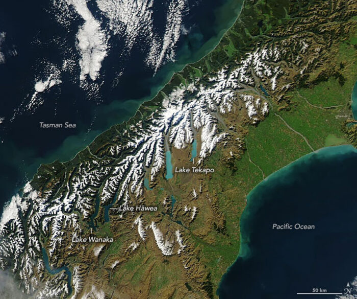 Satellite image showing lakes and snowy areas on New Zealand’s South Island.