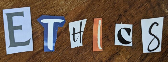 Letters cut from a magazine spelling out the word "ethics".