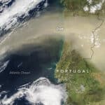 A massive plume of sand and dust was pushed northward from the Sahara desert by the calima, a warm southeasterly wind prevalent in North Africa in the winter, as seen in a satellite view of Spain and Portugal. Image: February 21, 2016, NASA.