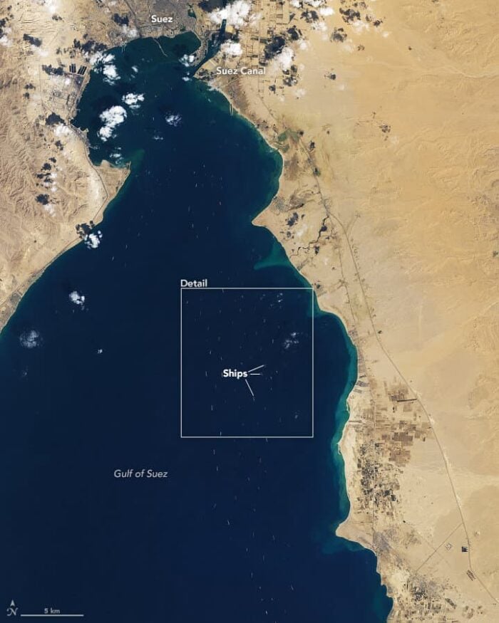 A satellite image of the entrance to the Suez Canal showing ship traffic.