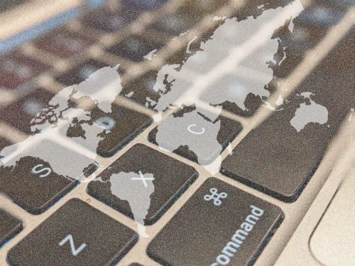 A grayscale map of the continents overlayed onto a fuzzy gray keyboard.