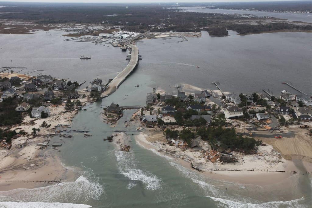 A photograph from an airplane looking at damaged houses along a beach in New Jersey after a hurricane.