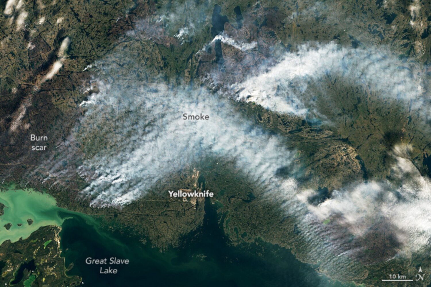 Satellite imagery of a wildfire burning in Canada with smoke streaming from the area.