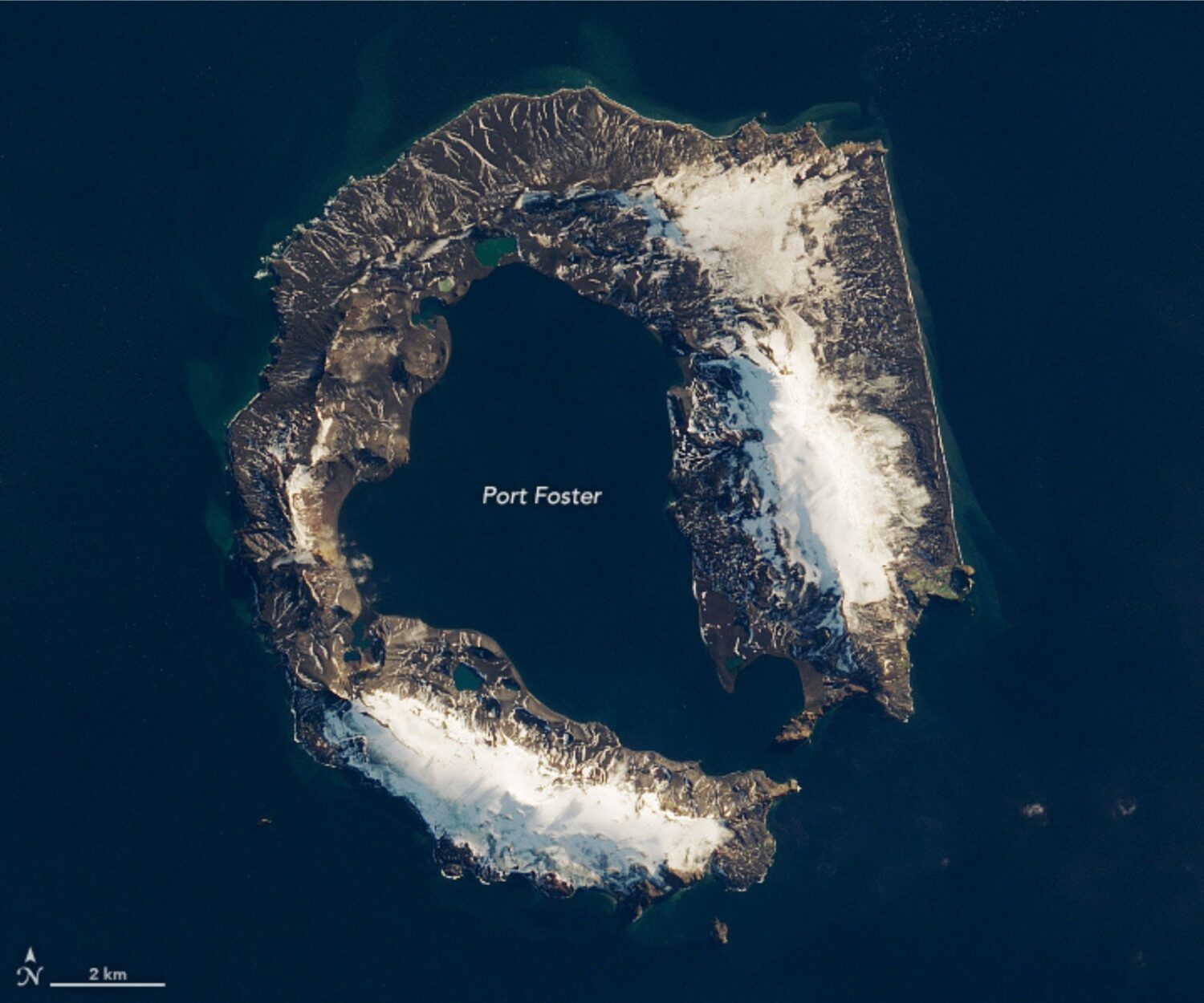 A satellite image of a horseshoe shaped island.