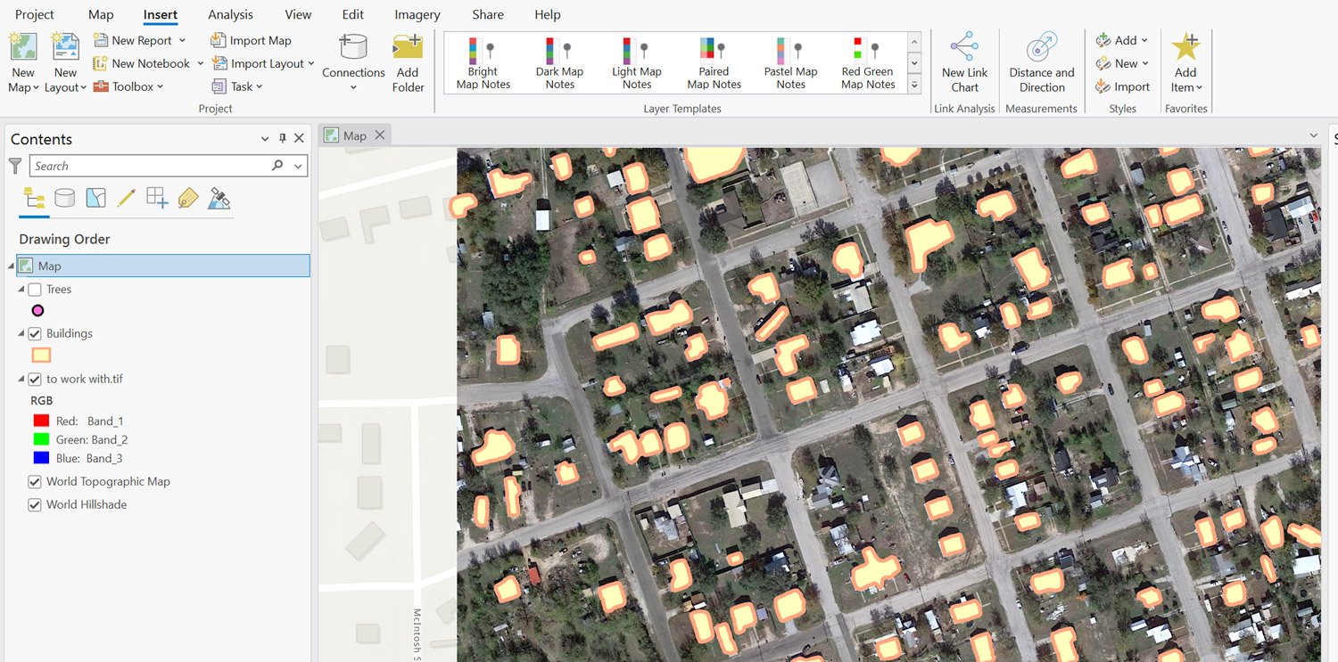 Screenshot showing yellow building footprints on top of a satellite imagery.