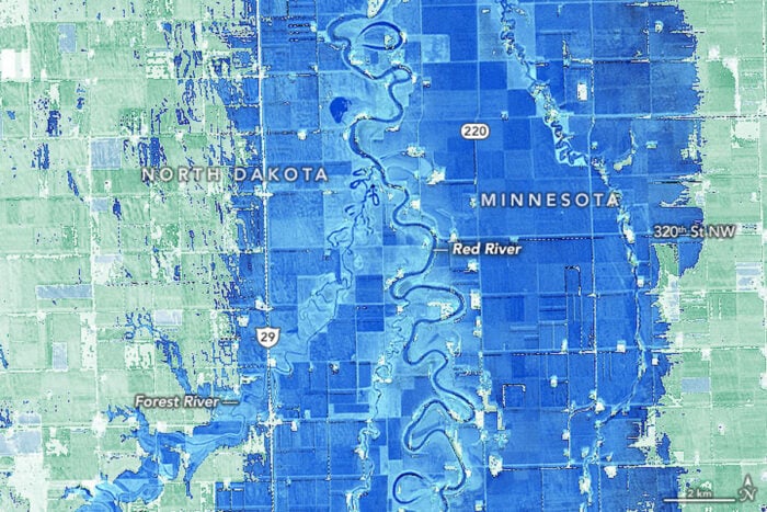 A satellite imagery that has NDWI calculations in blue to show the extent of flooding.