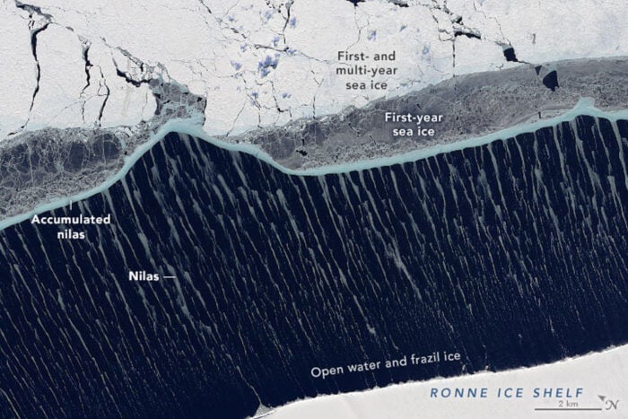 A satellite image showing wispy thin streaks of new sea ice.