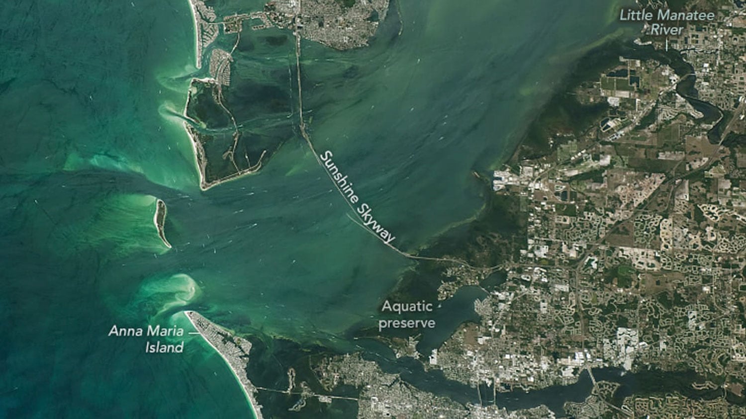 A photo taken from space that has been labeled with place names of an open water estuary.