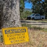 Crews working sign at Bear Creek Redwoods Open Space Preserve.