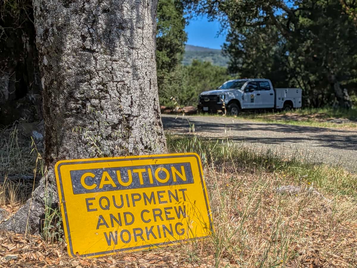 Crews working sign at Bear Creek Redwoods Open Space Preserve.